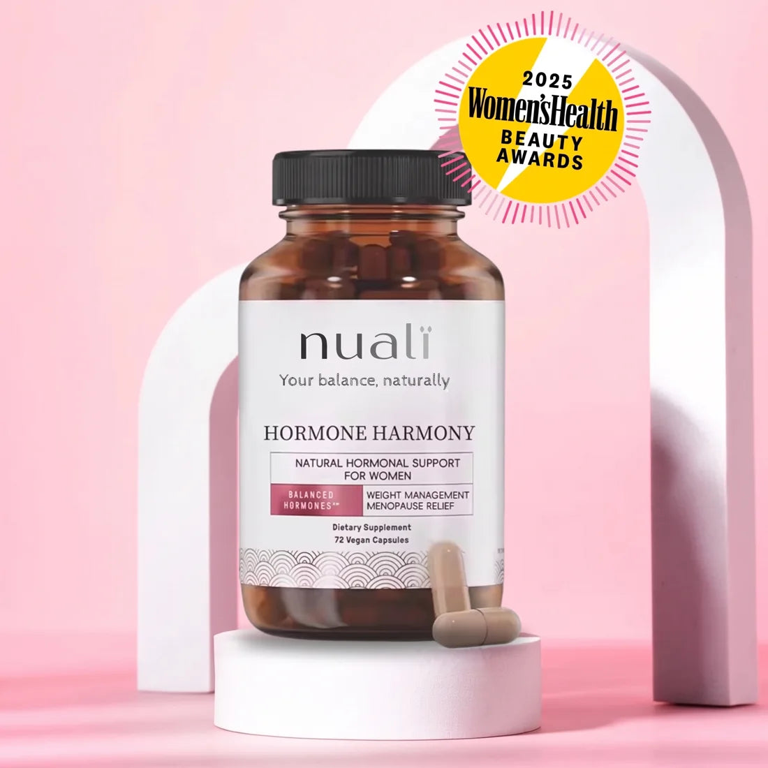 Jar of Nualï capsules on a pink stand