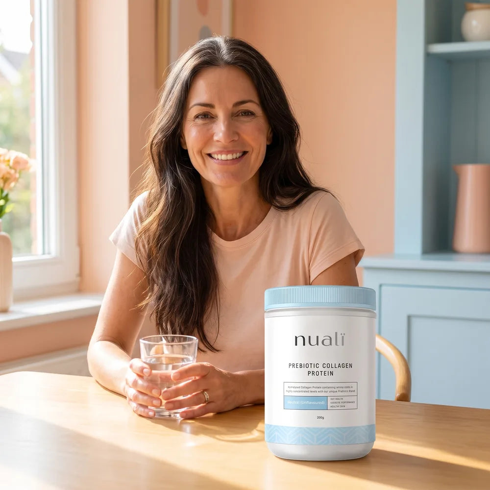 Woman smiling at her breakfast table with her collagen