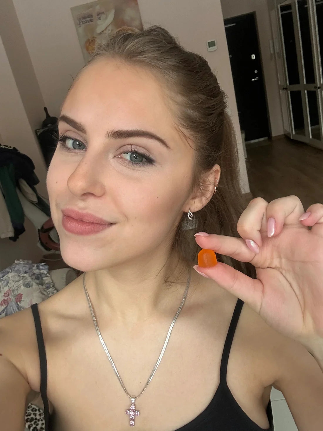Young woman holding a gummy