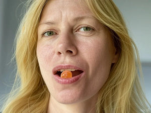 Woman with a gummy between her lips