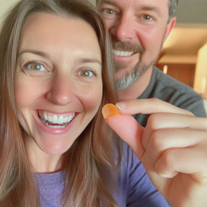 Couple smiling, holding a gummy
